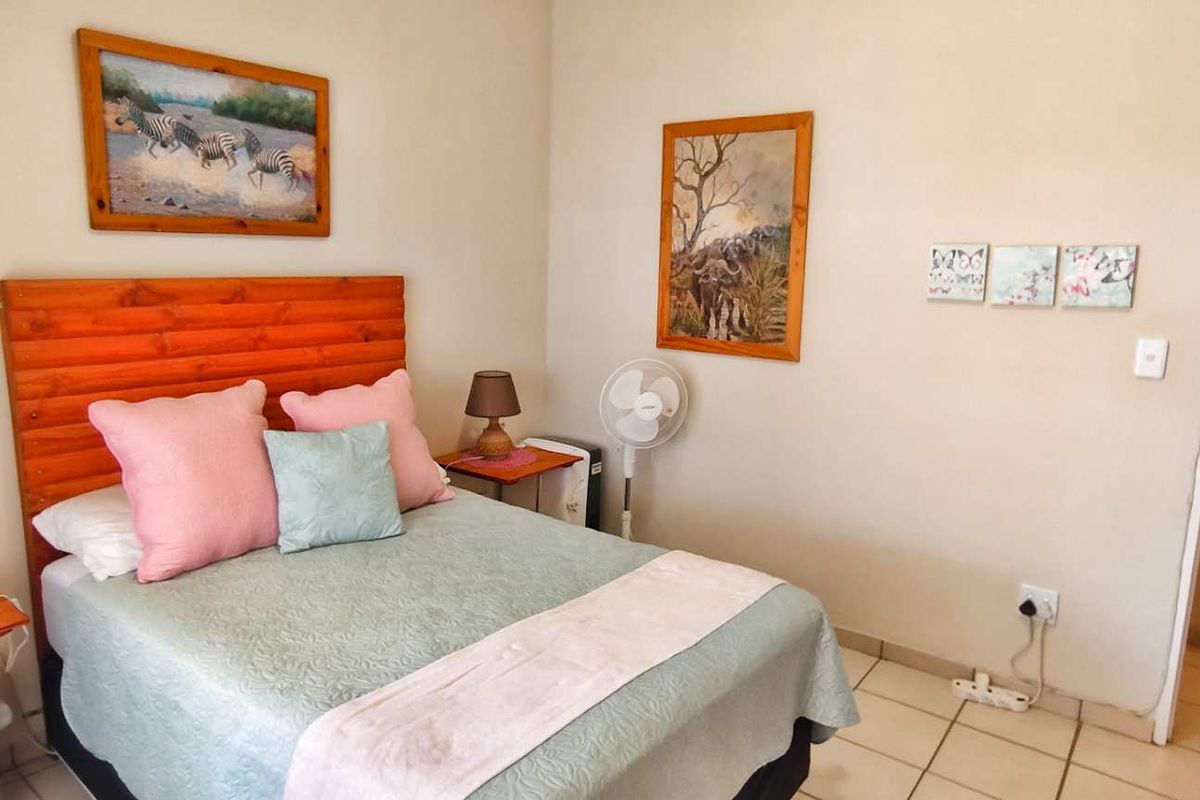A bedroom featuring tiled flooring and a neutral wall finish, providing a functional and comfortable living space.