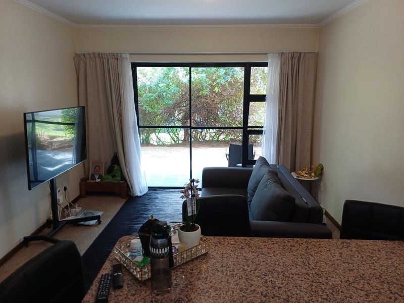 Open plan living area featuring a granite breakfast bar and large sliding glass doors providing access to the outdoor space.