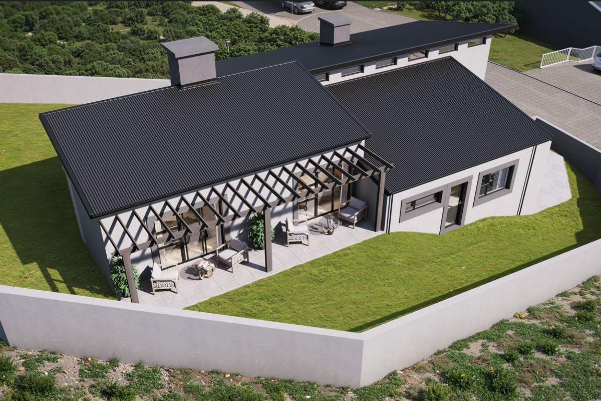 Aerial view of a modern house featuring a dark corrugated metal roof, a covered patio with a pergola, and a surrounding perimeter wall.