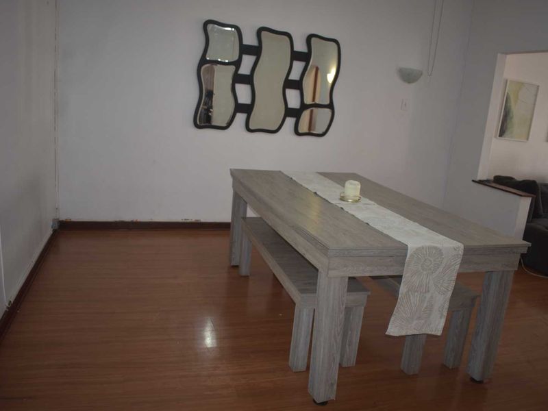 Dining area featuring laminate flooring and neutral walls, requiring minor repairs to skirting boards and finishes to enhance the space.