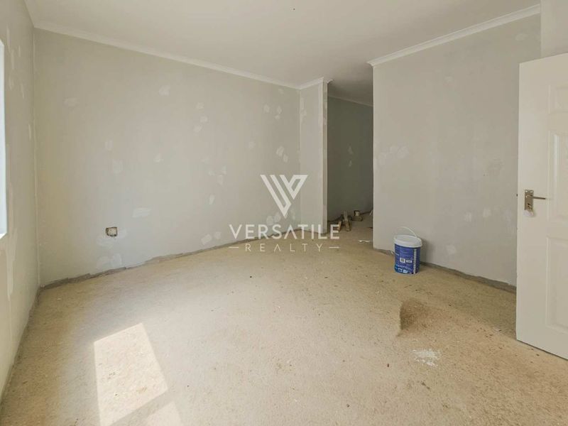 An empty bedroom currently undergoing renovation with unfinished walls and exposed flooring, offering a blank canvas for custom interior finishes.
