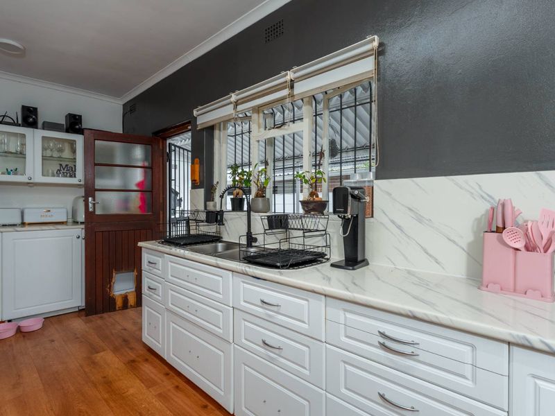Delightfully spacious and loved family home adorned by lovely secure and established sunny garden plus built-in Braai area - this is a must see! - Photo 7