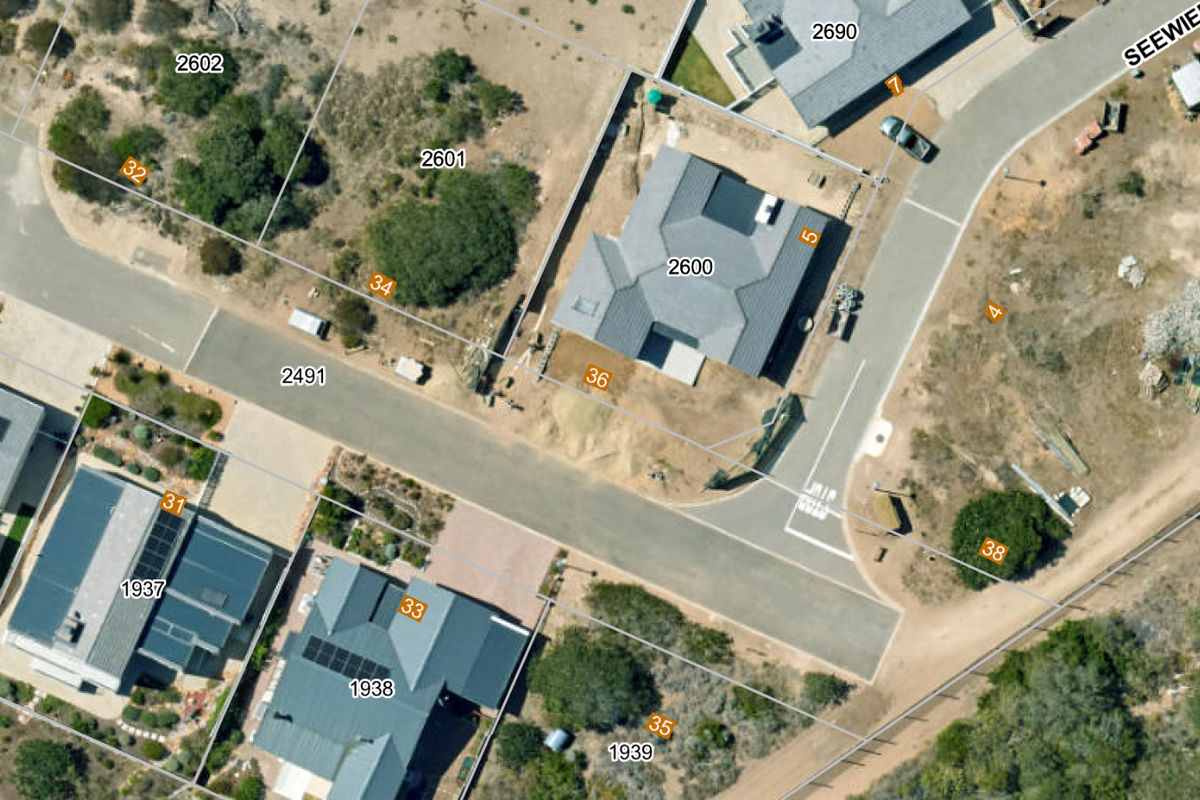 An aerial view of a residential neighborhood showing street layout, property boundaries, and existing housing developments.
