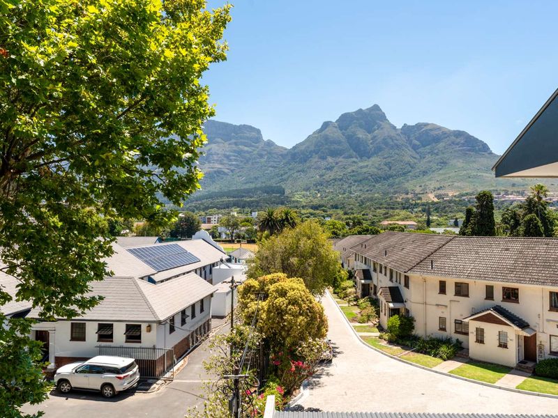 Elevated view overlooking the residential complex, surrounding neighborhood, and scenic mountain range in the distance.