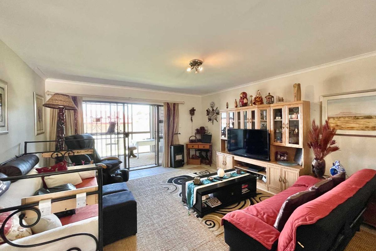 Spacious living room featuring large sliding glass doors leading to an outdoor patio area, providing natural light and seamless indoor-outdoor flow.