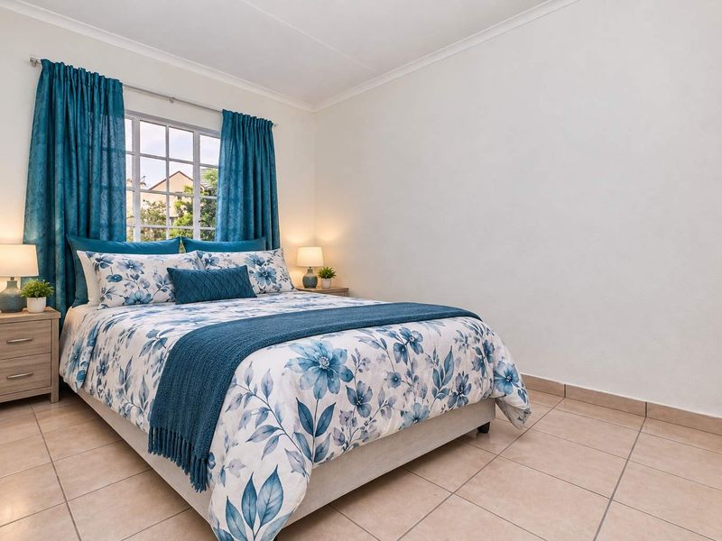 A well-maintained bedroom featuring neutral tiled flooring, a built-in cupboard, and a window with security bars, offering a clean and functional living space.