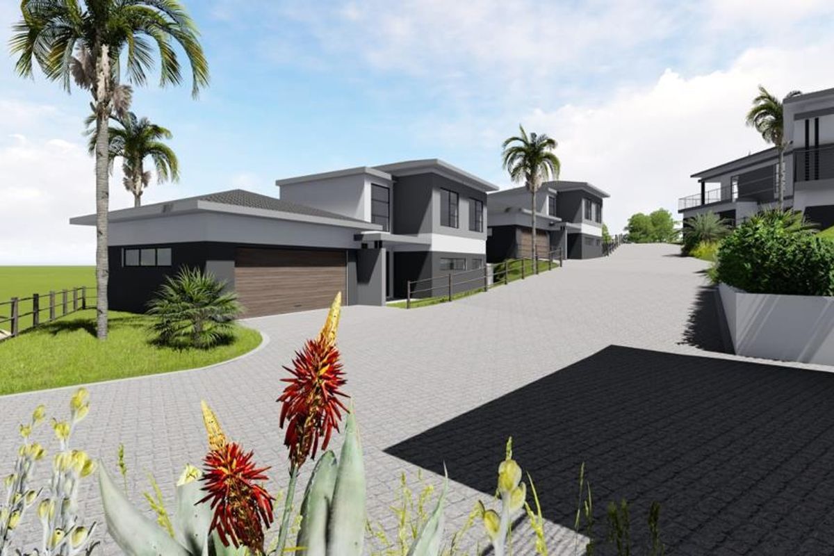 A modern residential development featuring contemporary multi-level homes with paved driveways, integrated garages, and landscaped surroundings.
