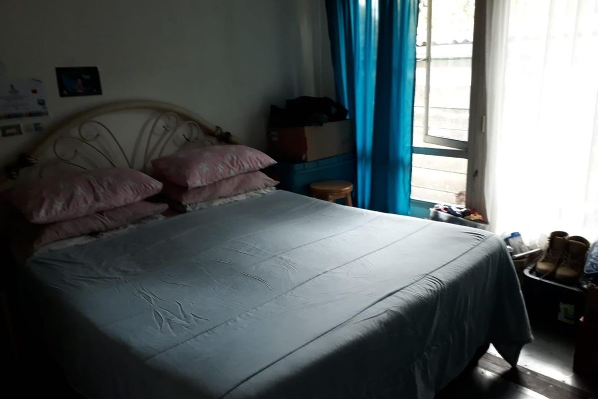 A bedroom featuring a sliding glass door providing natural light and access to the exterior.