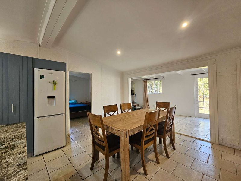Open plan dining area featuring tiled flooring, recessed lighting, and direct access to the exterior through french doors.