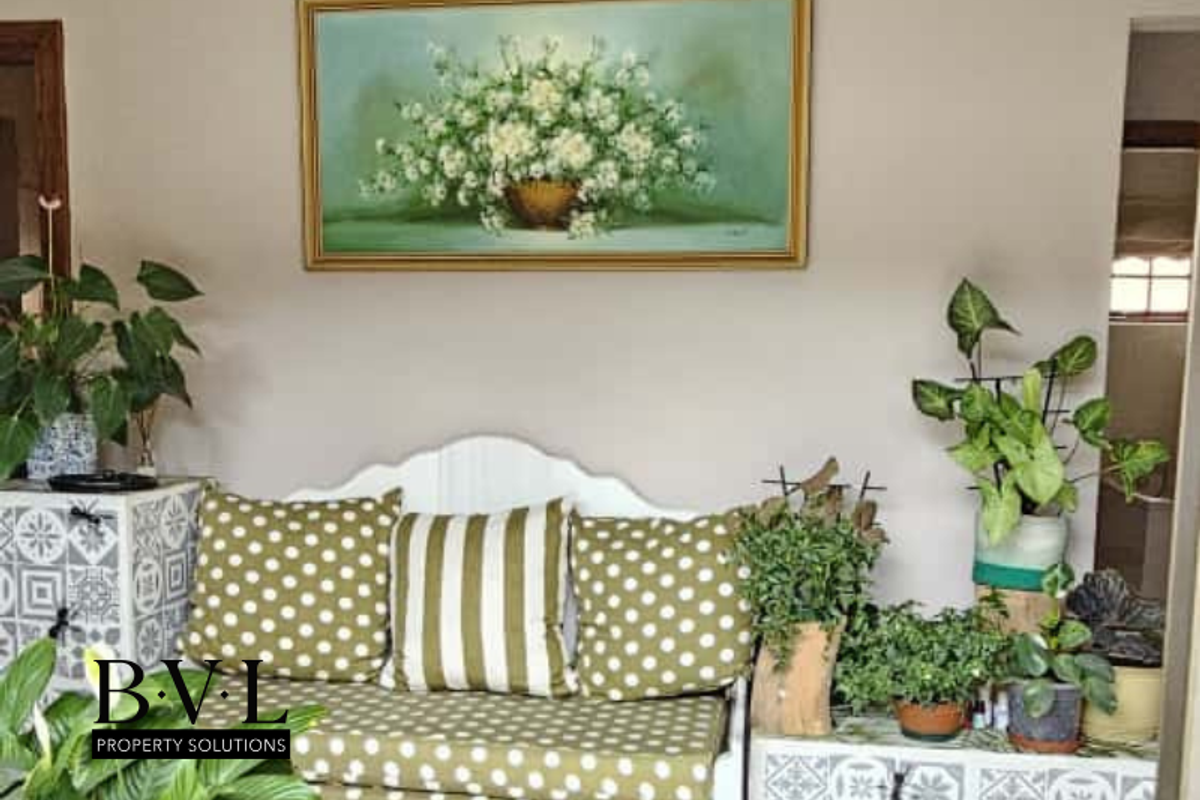 A cozy living area featuring neutral wall tones and decorative cabinetry, creating a welcoming and comfortable space.