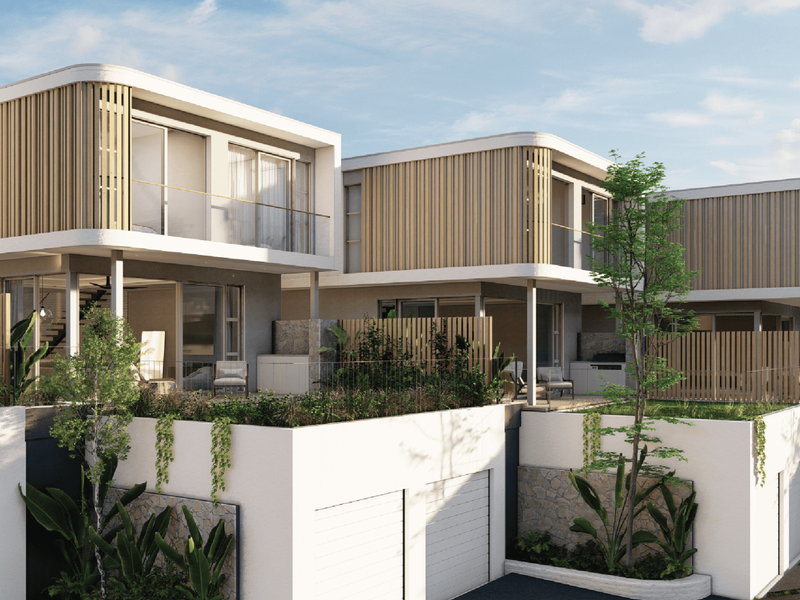 Modern townhouse exterior featuring timber slat detailing, glass balustrades, and integrated garage access with landscaped terraced levels.