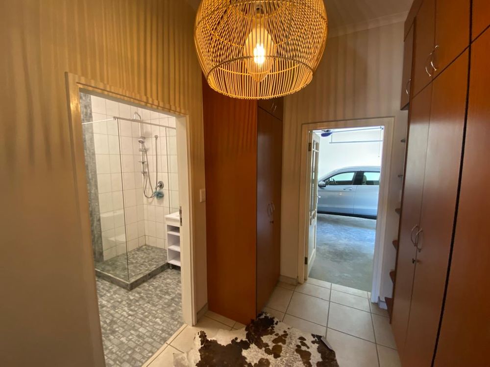 Hallway leading to garage. BIC for extra storage. Bathroom 1