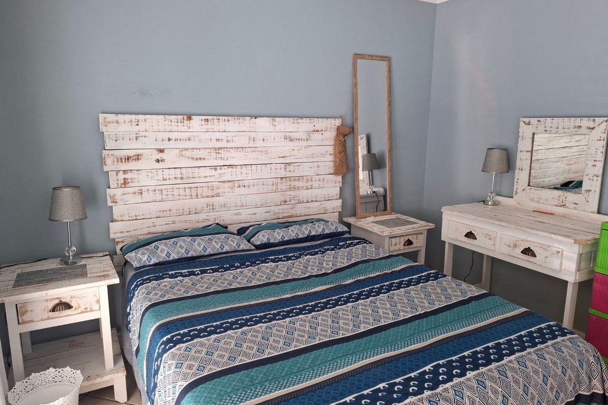 A bedroom featuring tiled flooring and neutral wall paint, providing a functional space for rest.