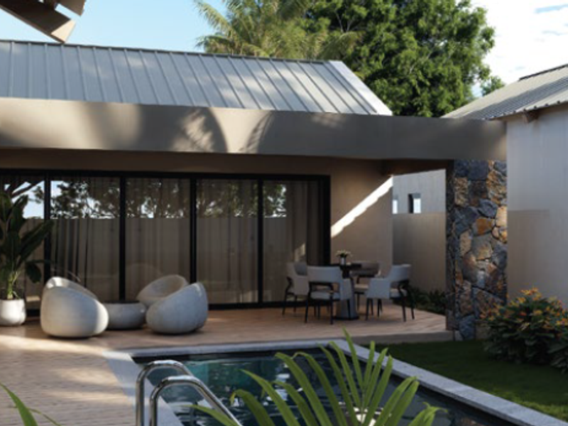 A modern outdoor living space featuring a swimming pool, covered patio with decking, and elegant stone wall accents.