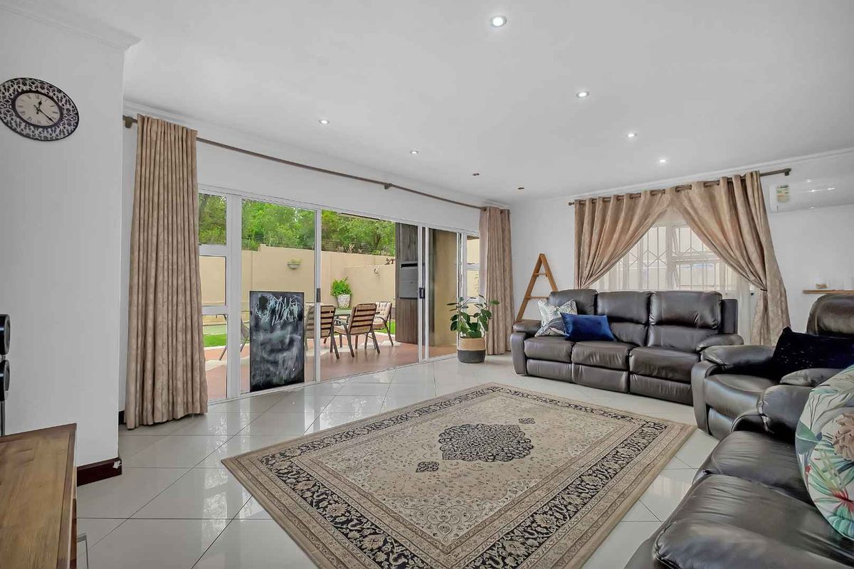 Spacious living room featuring large sliding glass doors that provide seamless access to the outdoor patio area and abundant natural light.