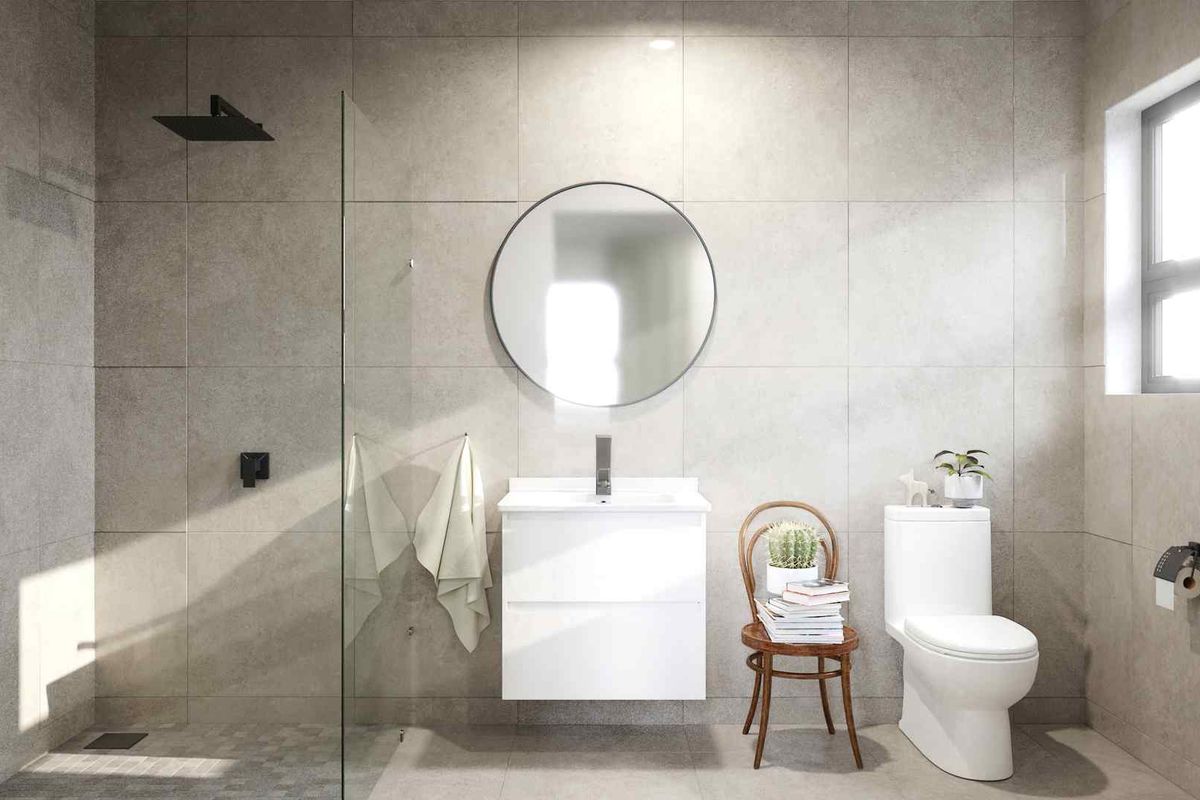Modern bathroom featuring large format grey wall tiles, a frameless glass walk-in shower, a wall-mounted vanity, and a contemporary toilet.