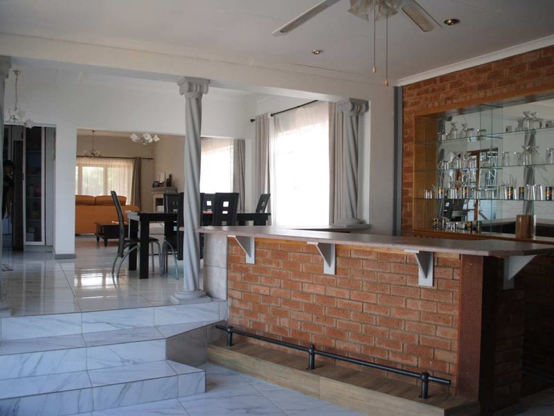 Renovated, built up, and expanded into a neat four-bedroom home with multiple living rooms and Bar area - Photo 8
