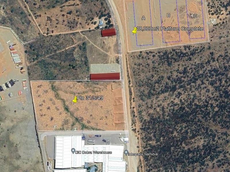 Aerial view of an industrial site featuring an 18,000m2 completed platform, a 500kVA transformer, and existing warehouse facilities.