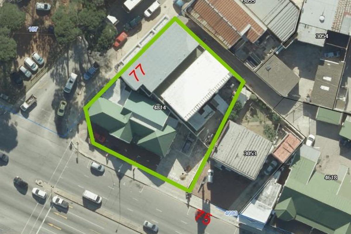 Aerial view of the property showing the building footprint, roof structure, and surrounding site layout.