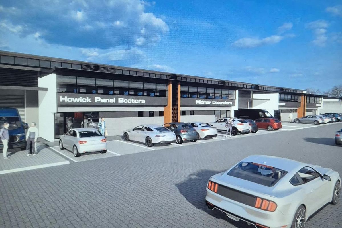 A perspective view of a modern commercial industrial complex featuring multiple units with paved parking and signage.