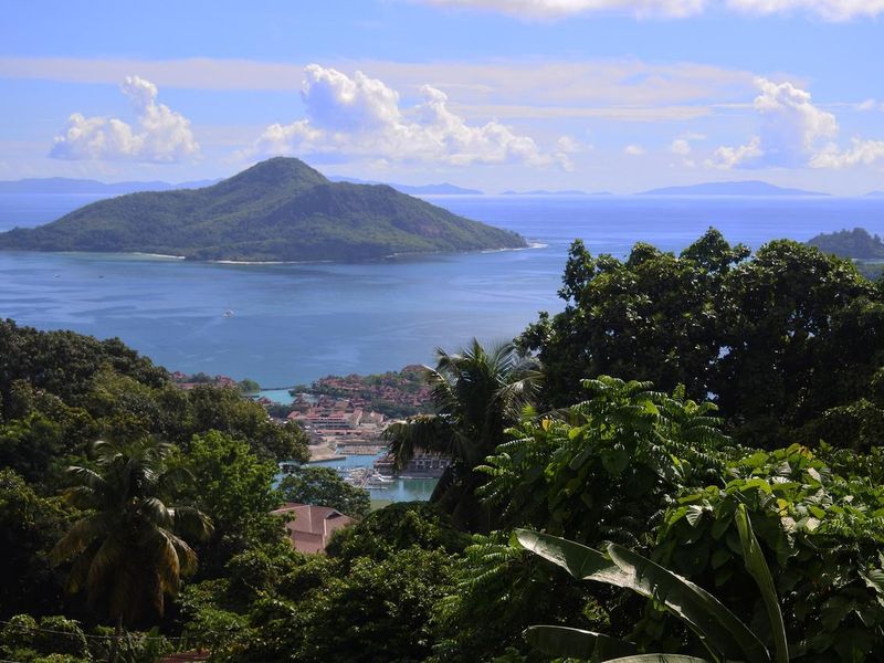 A scenic elevated view overlooking the coastline, marina, and surrounding islands, showcasing the natural beauty and landscape of the property location.