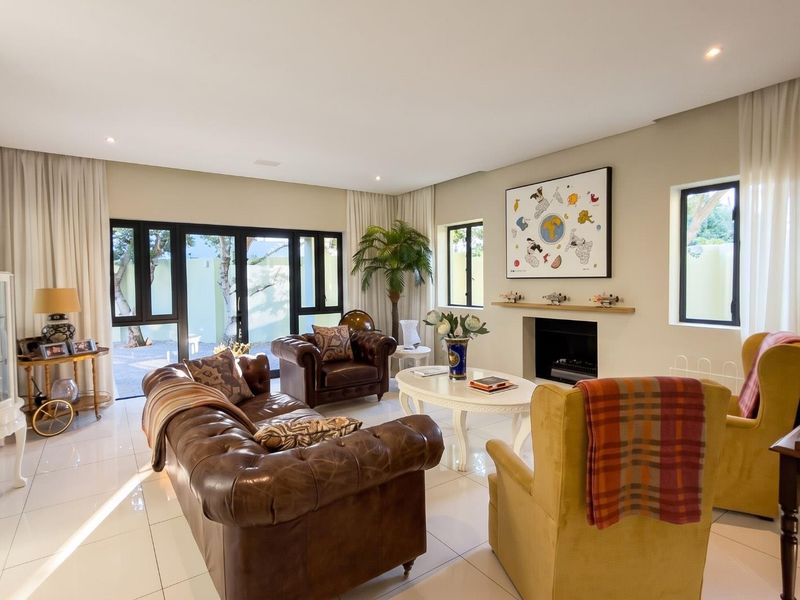 Spacious living room featuring tiled flooring, a built-in fireplace with mantelpiece, and large glass sliding doors providing access to the outdoor area.