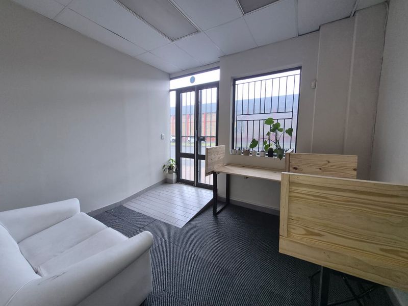 Entrance area featuring a security gate, tiled flooring at the threshold, carpeted main area, and security bars on the window.