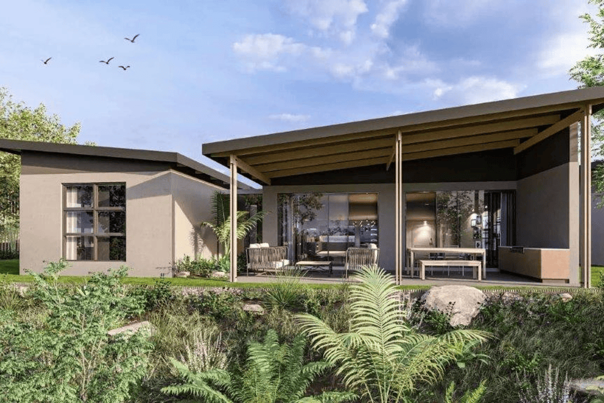 A modern townhouse exterior featuring a covered patio area, large glass sliding doors, and a contemporary mono-pitch roof design.