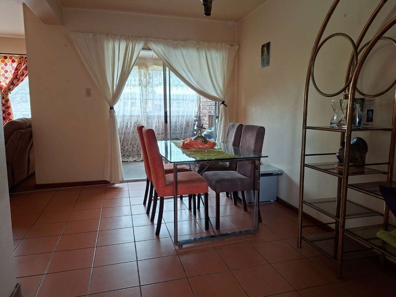 Dining area featuring ceramic tile flooring and a sliding glass door providing access to an outdoor space.