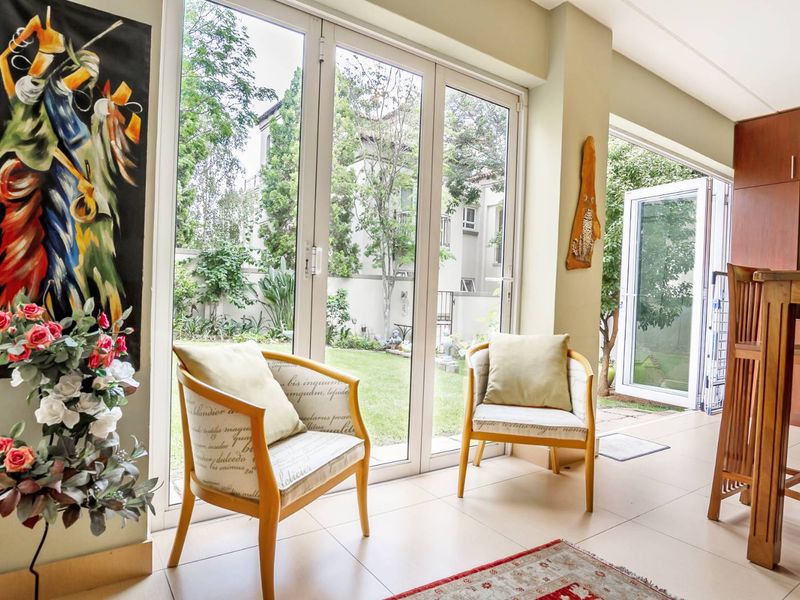 Bright living area featuring large glass sliding doors that provide seamless access to the garden and ample natural light.