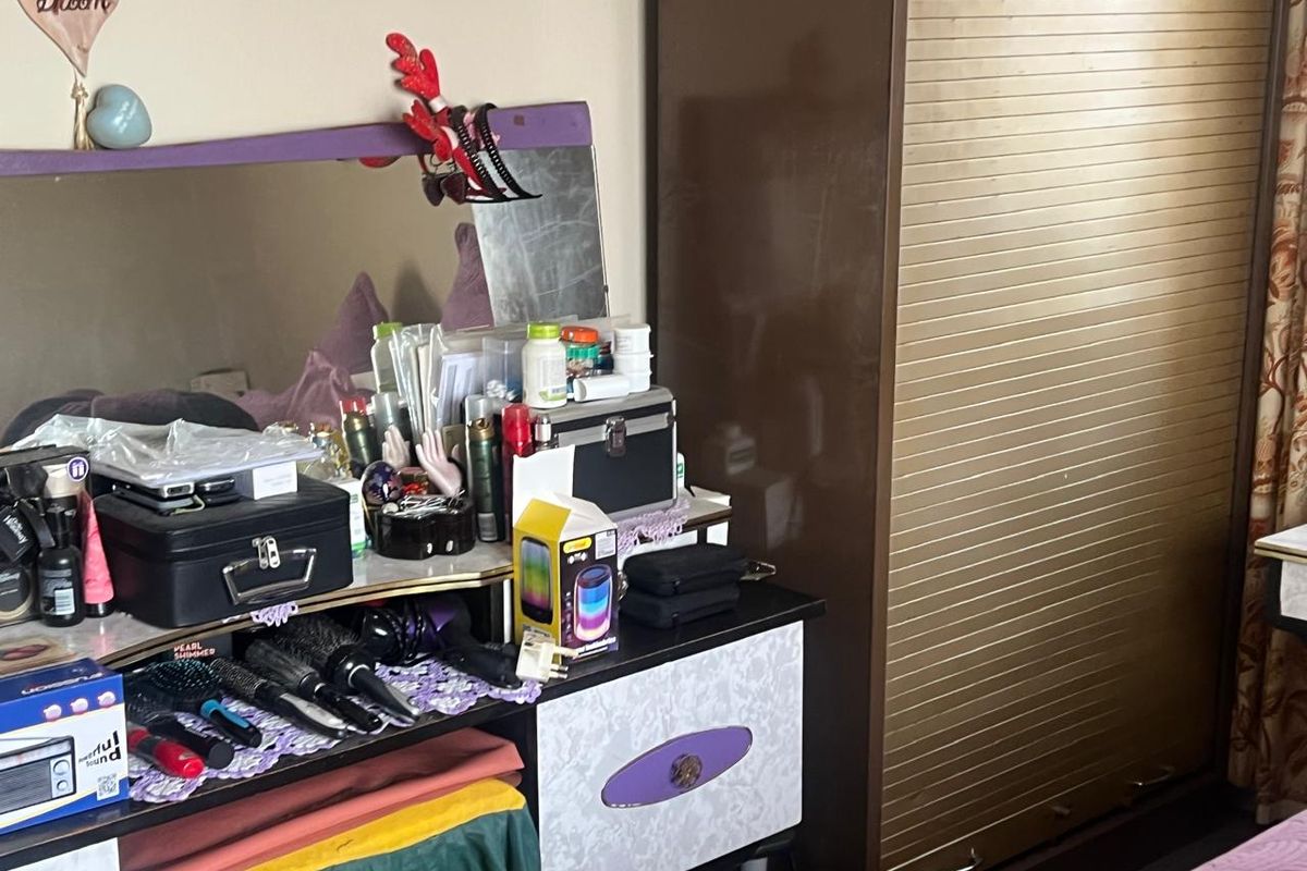 A bedroom interior featuring a built-in wardrobe with sliding doors.