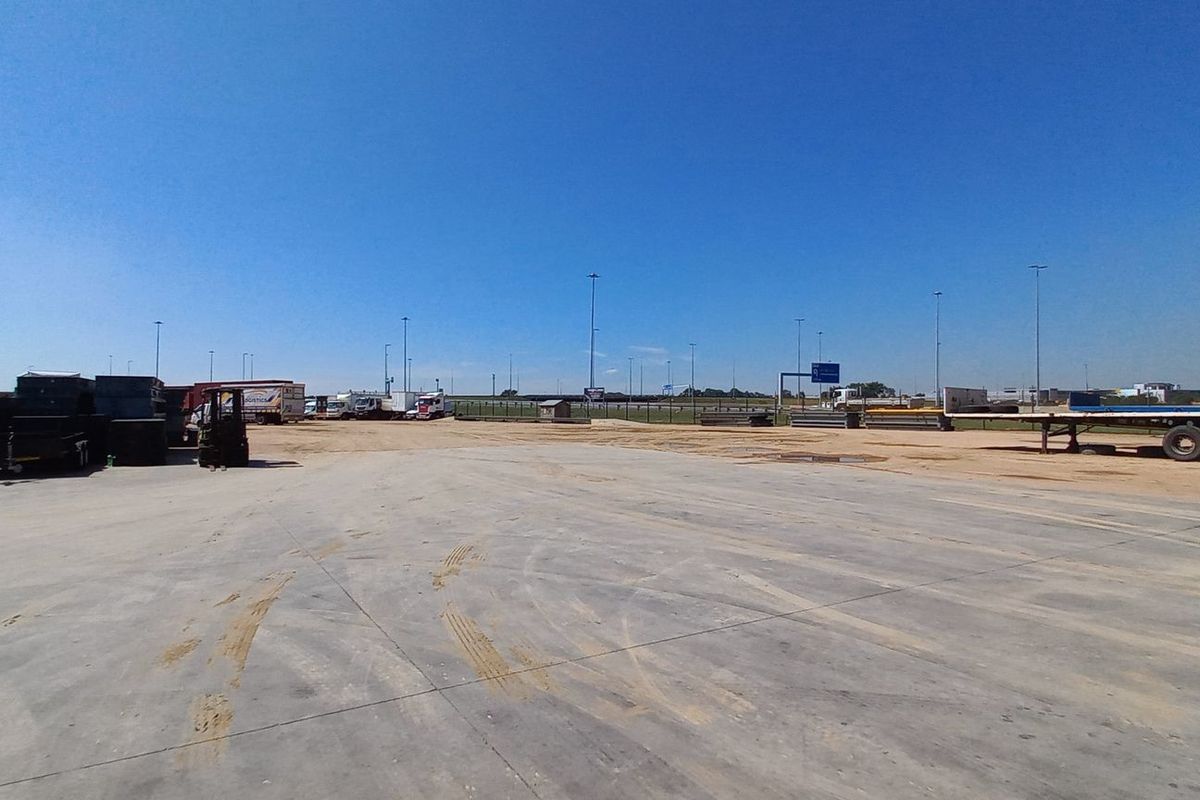 Expansive industrial concrete yard providing ample space for vehicle maneuvering, logistics operations, and outdoor storage.