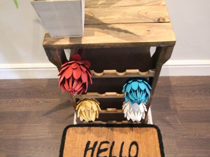 A close-up view of a small wooden rack and decorative items on a wooden floor.