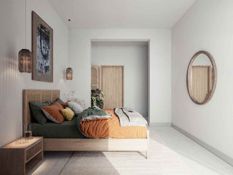 A bright and modern bedroom featuring clean lines, neutral walls, and warm wood accents, creating a serene and inviting atmosphere.