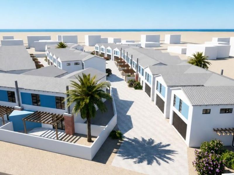 An aerial perspective of a modern townhouse development featuring uniform pitched roofs, paved driveways, and private outdoor pergola areas.