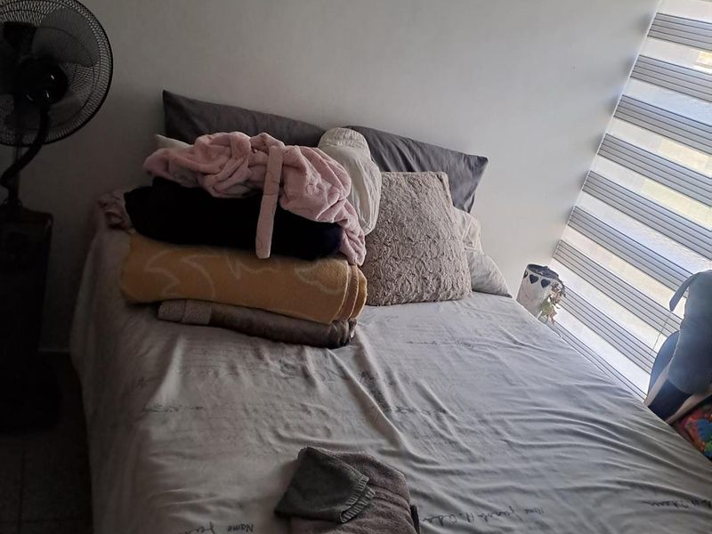 A bedroom featuring modern zebra blinds, providing adjustable light control and privacy.