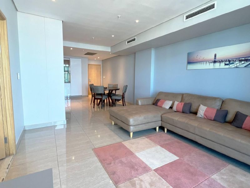 Spacious open-plan living and dining area featuring modern porcelain floor tiles, recessed downlighting, and integrated ducted air conditioning.