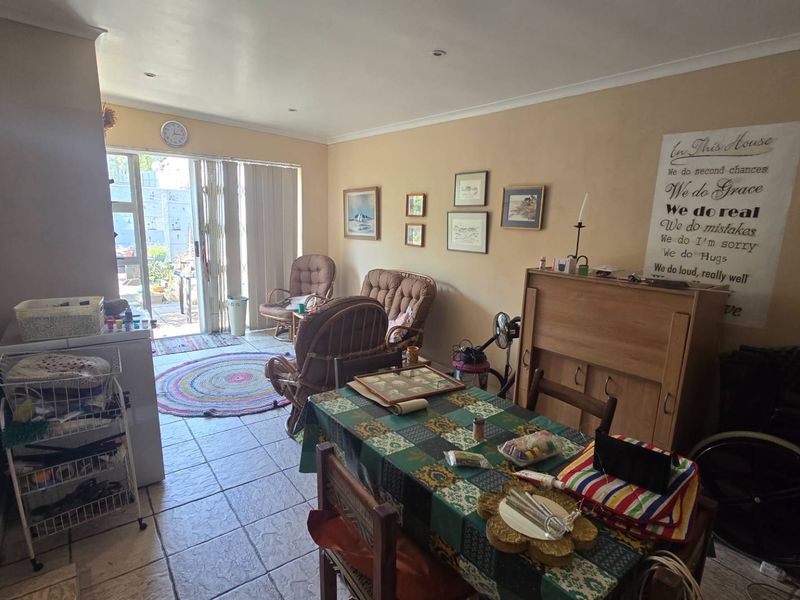 Open plan living and dining area featuring tiled flooring, recessed lighting, and a sliding glass door providing access to the outdoor space.