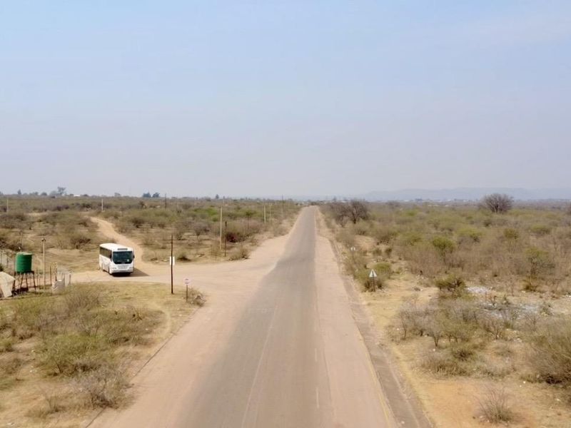 An aerial view of the rural landscape showing the access road and surrounding farm terrain.