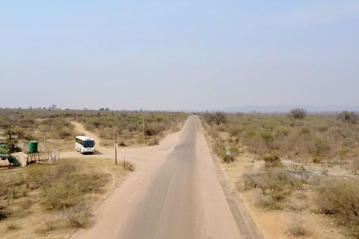 An aerial view of the rural landscape showing the access road and surrounding farm terrain.