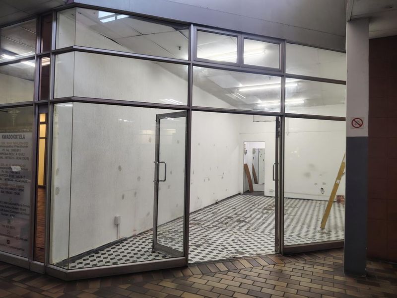 Vacant retail storefront featuring a glass facade, aluminum framing, and checkered tile flooring, suitable for a variety of commercial business applications.