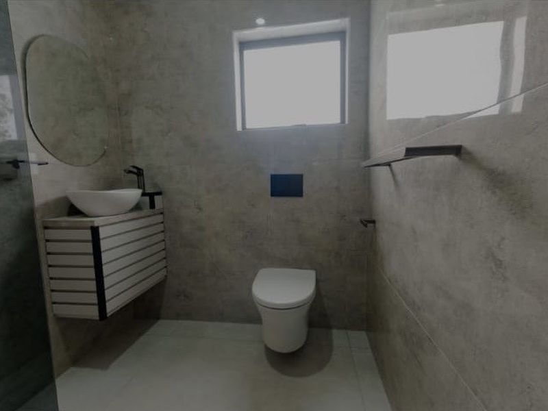 Modern bathroom featuring a wall-hung toilet with concealed cistern, wall-mounted vanity with vessel sink, and contemporary floor-to-ceiling tiling.
