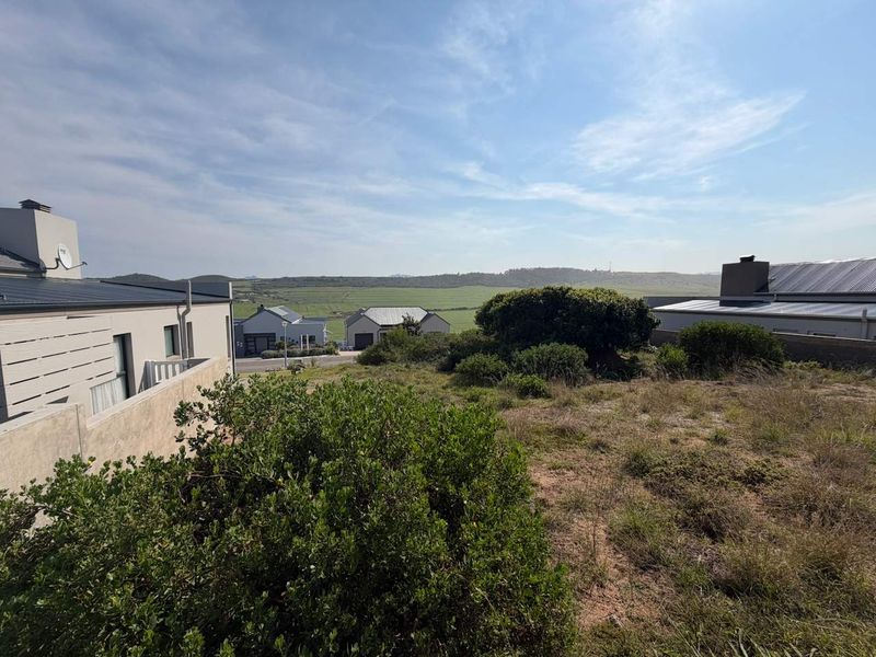 A scenic view overlooking the surrounding residential estate and natural landscape, showcasing the property's elevated position and open outlook.