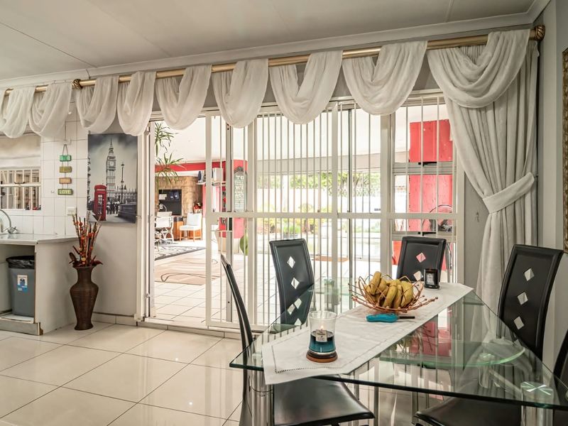 Open-plan dining area featuring tiled flooring and sliding glass doors that provide seamless access to the outdoor patio space.