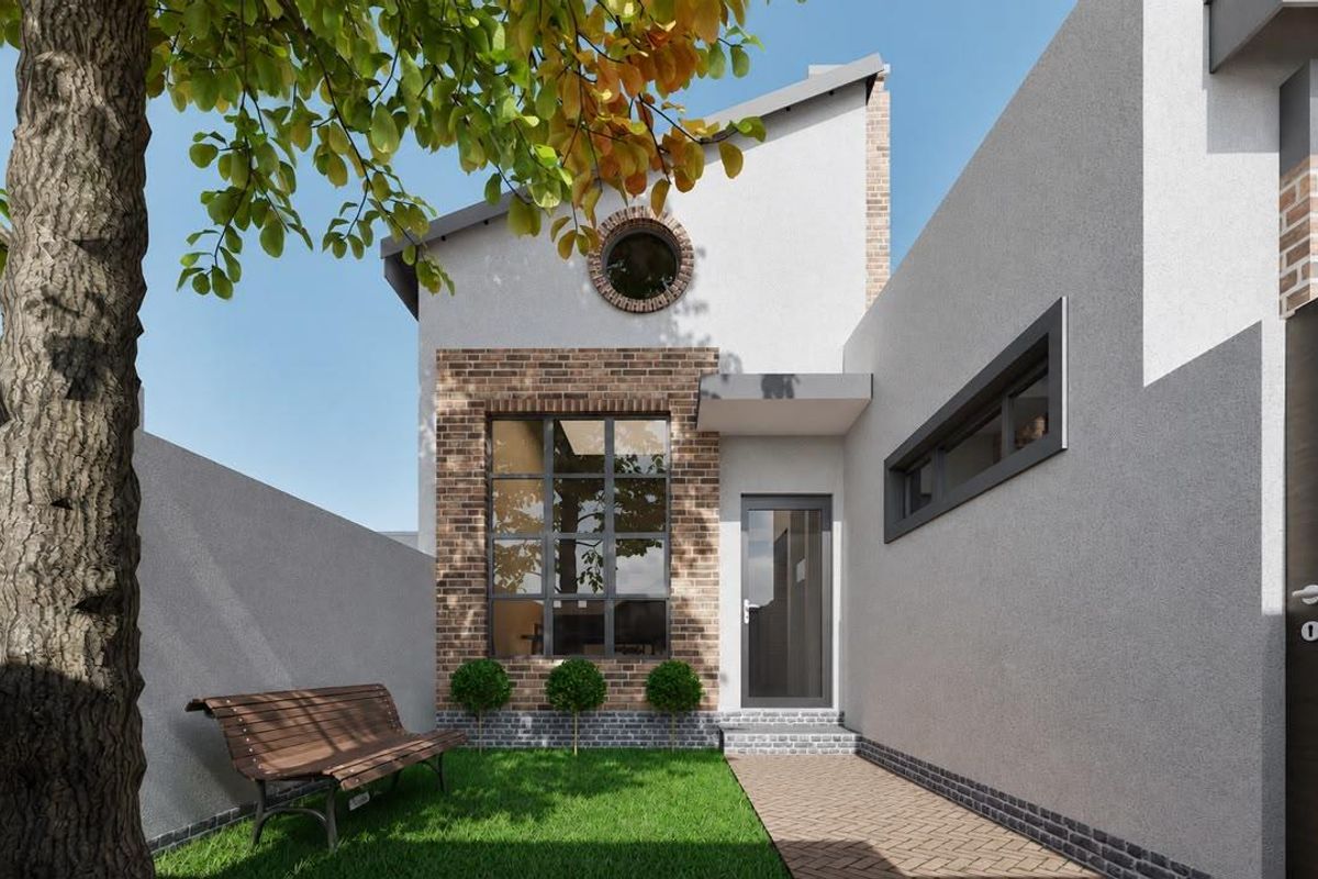 A modern townhouse rear exterior featuring a brick and render facade, a circular window, and a paved walkway leading to the entrance.