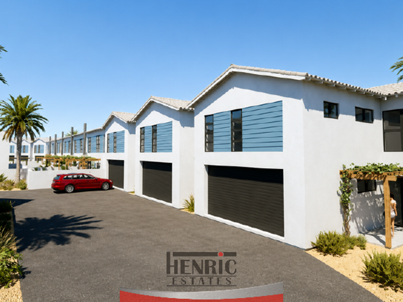A modern townhouse complex featuring a paved driveway, multiple garage access points, and contemporary architectural finishes with timber pergola detailing.