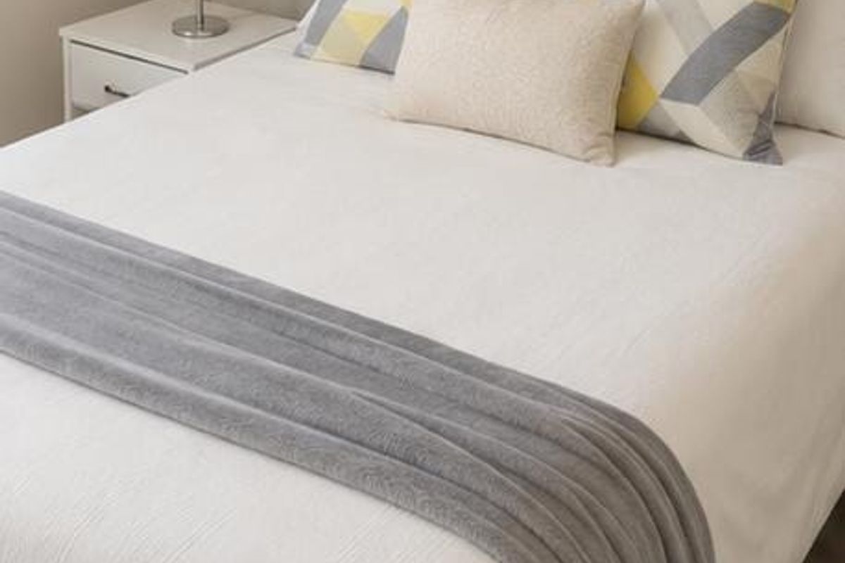 A well-presented bedroom featuring neutral wall finishes and light-toned flooring.