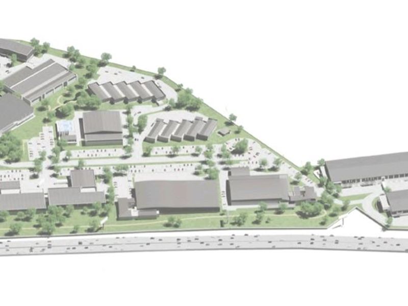 An aerial site plan rendering showing the layout of the industrial park, including multiple warehouse buildings, parking areas, and northern and southern access points.