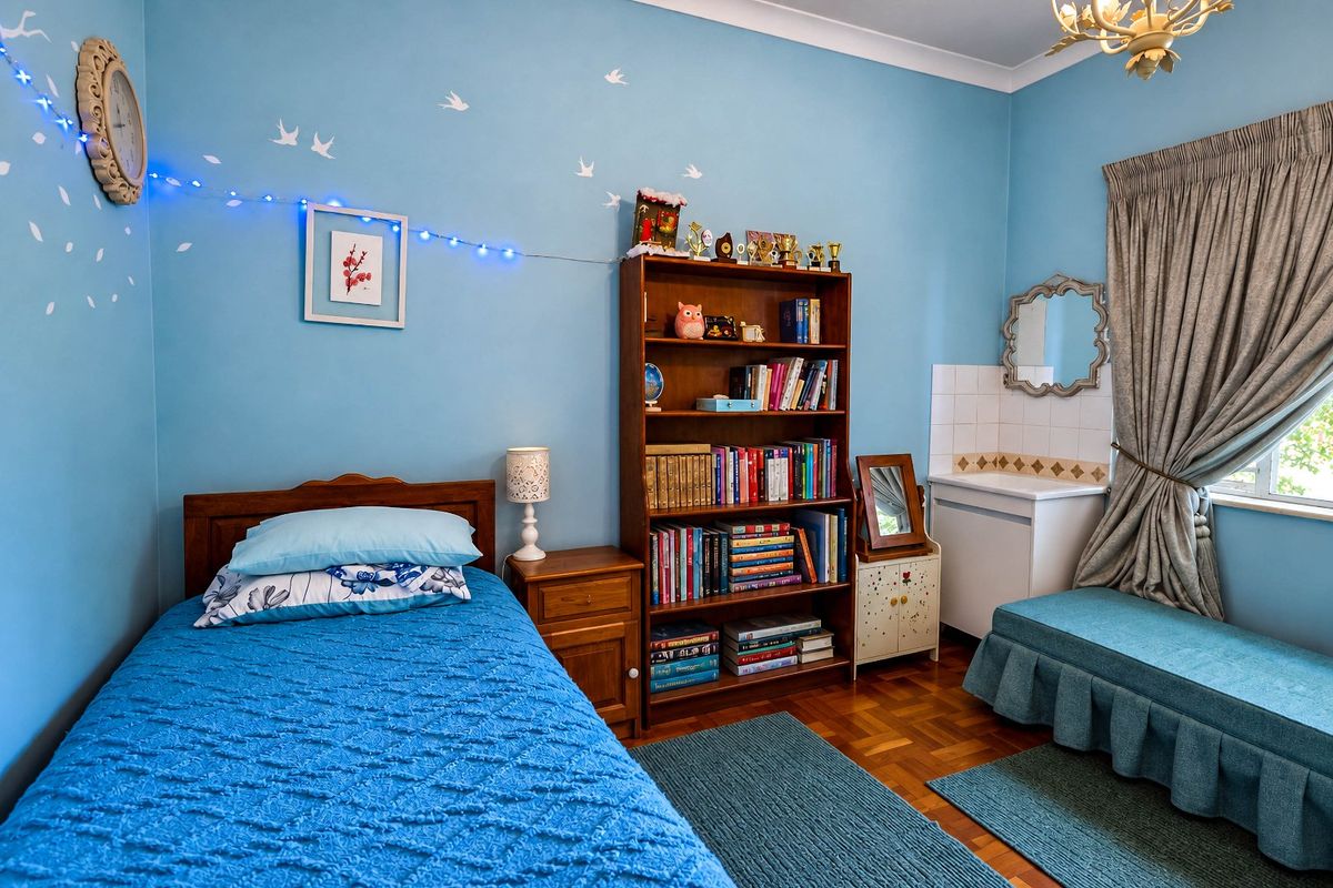 A bedroom featuring parquet flooring, a built-in vanity basin with tiled splashback, and coved ceiling details.