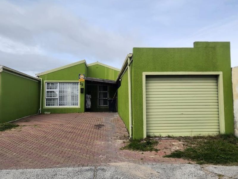 Front elevation of a single-story house featuring a paved driveway, integrated garage with a roller door, and security-fitted windows and entrance.